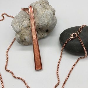 Rose-gold toned with iridescent peach pendant
